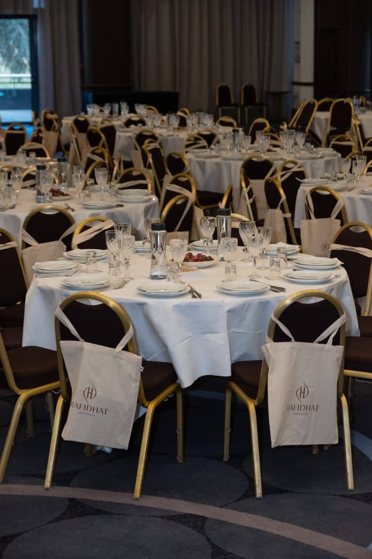 La salle dressée avant l'arrivée des participantes, un sac Hafidhat posé sur chaque chaise